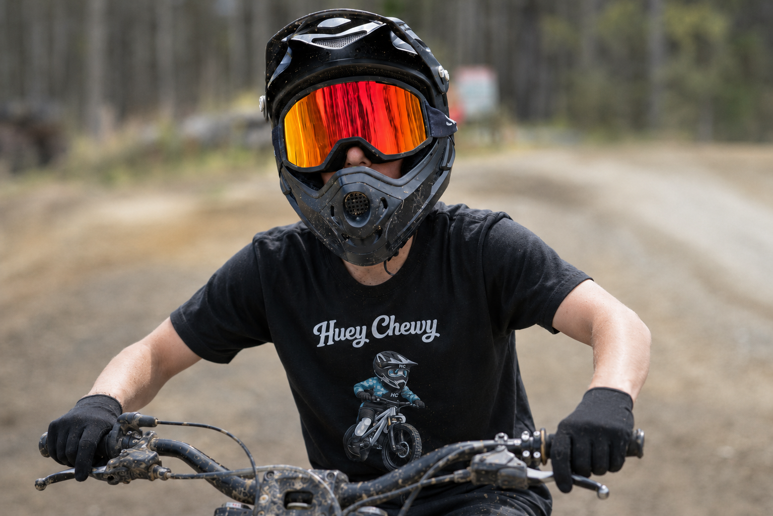 Boy mountain biking in the forest wearing Huey Chewy black mountain bike t-shirt
