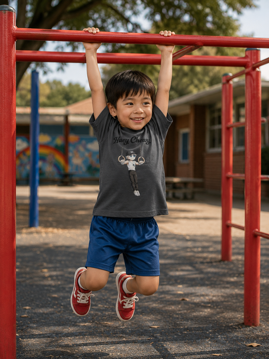 Boy swinging on the bars at the playground wearing Huey Chewy grey gymnast t-shirt