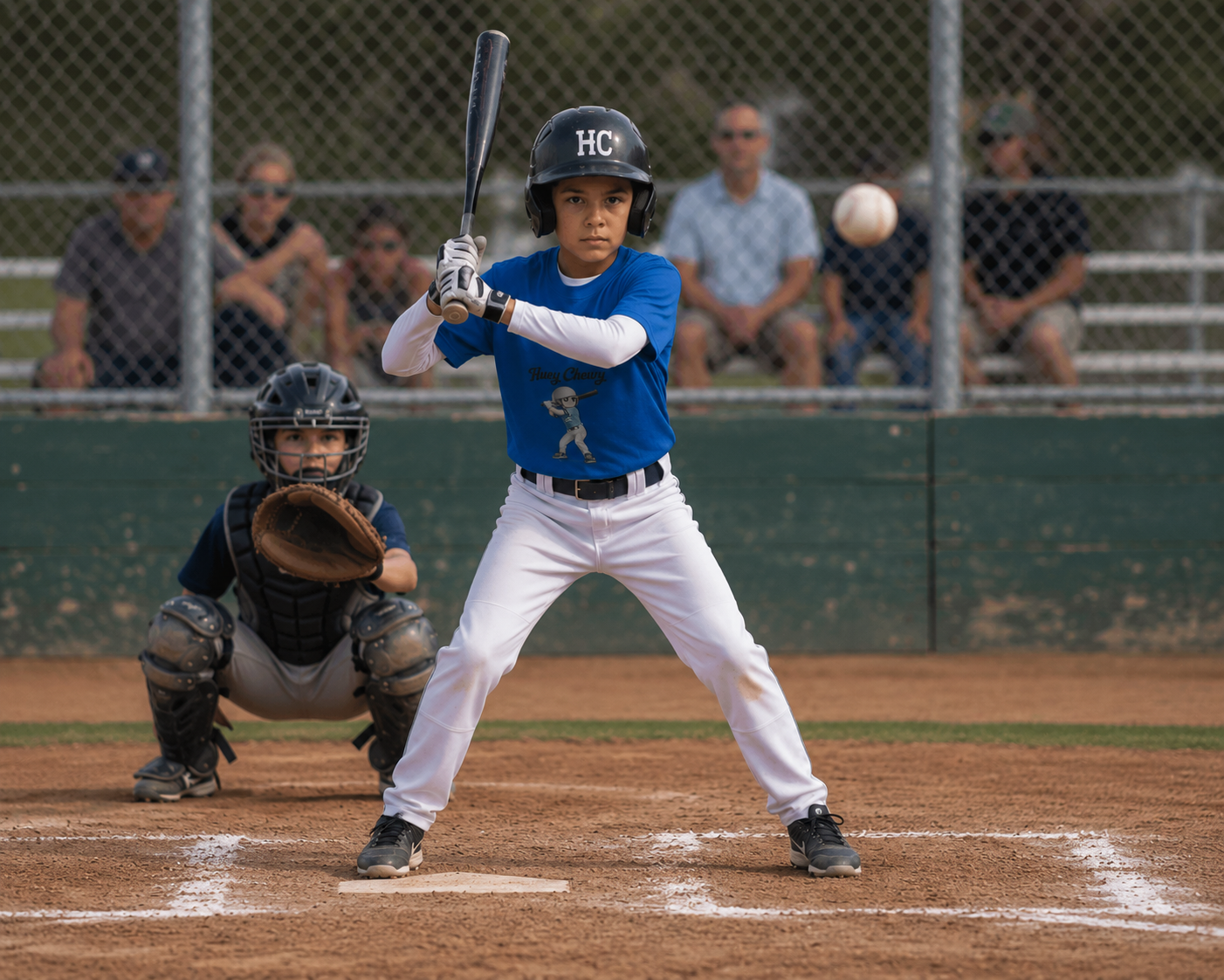 Boy playing baseball wearing Huey Chewy blue baseball t-shirt